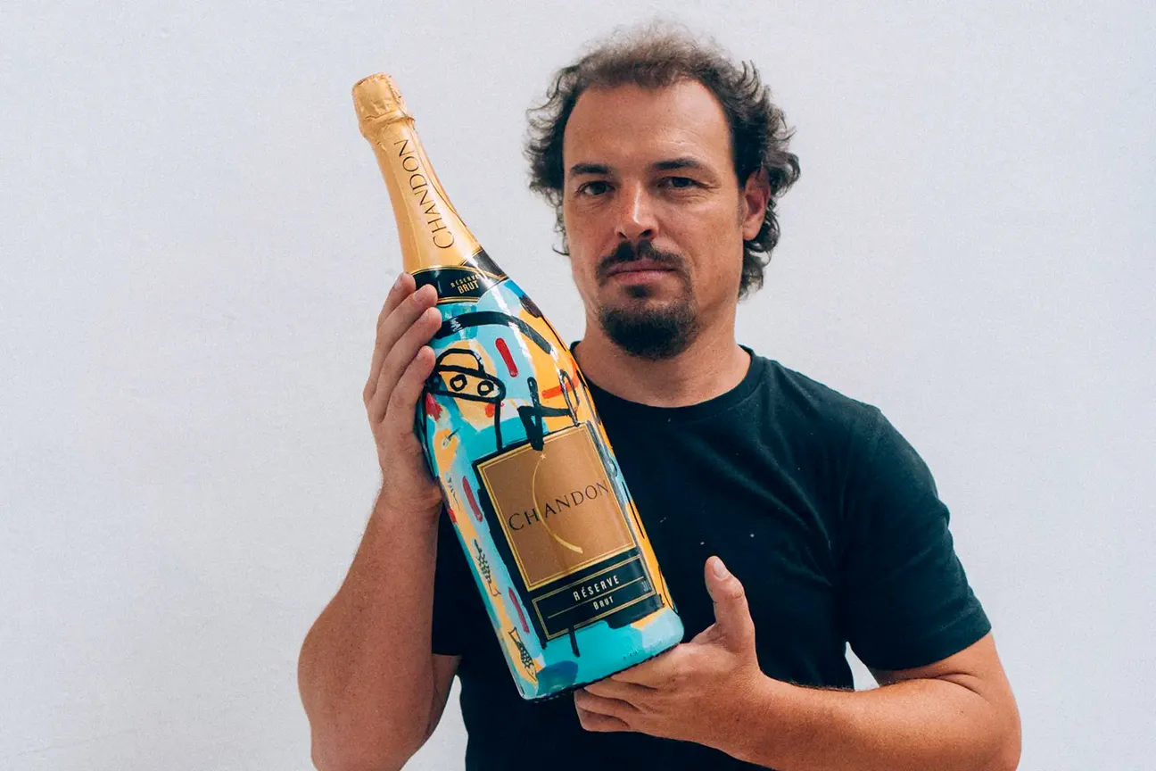 Artista com uma Jeroboam da Chandon pintada por ele